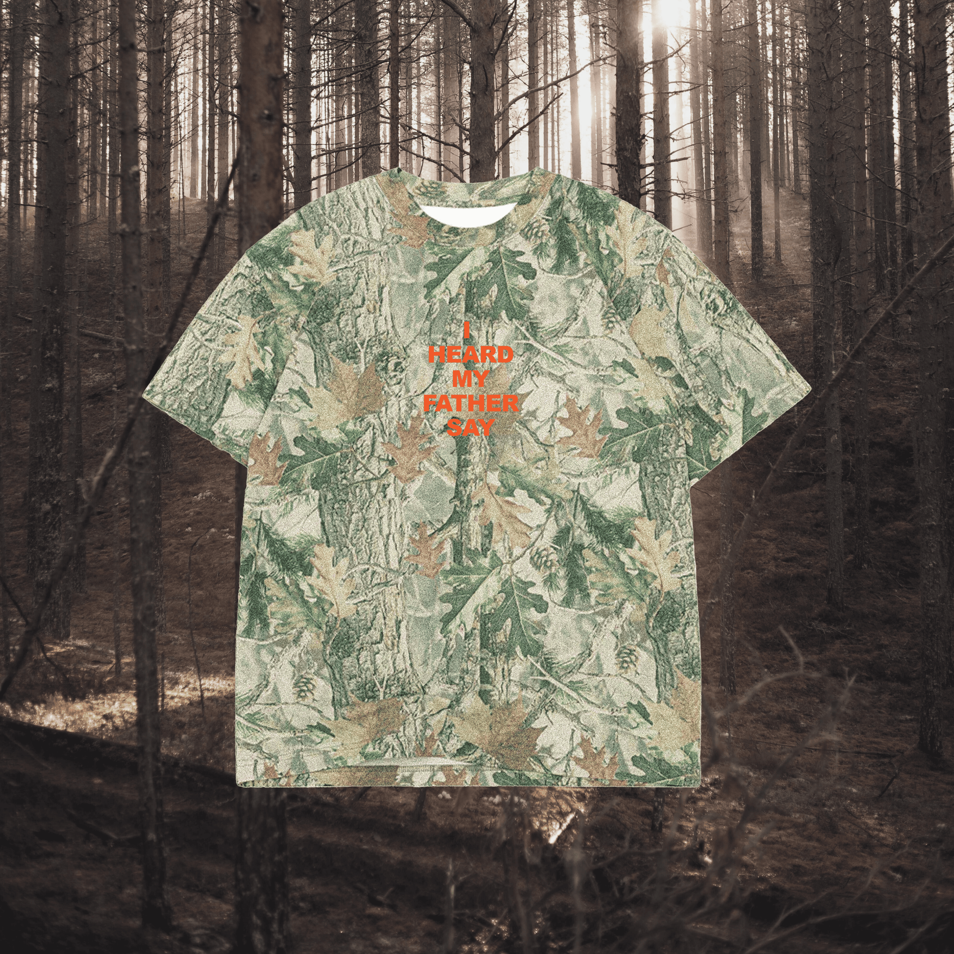 Camouflage-patterned t-shirt with text in a forest setting