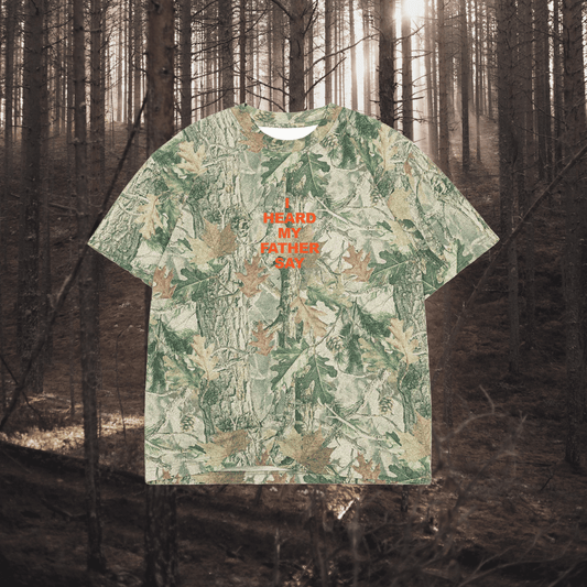 Camouflage-patterned t-shirt with text in a forest setting